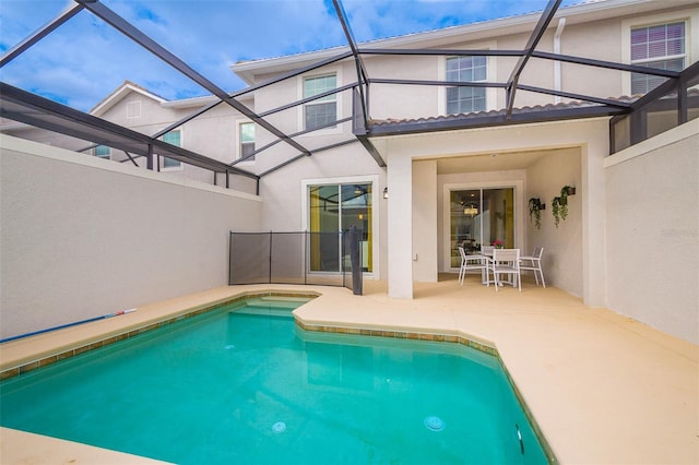 view of pool with a patio area and a lanai