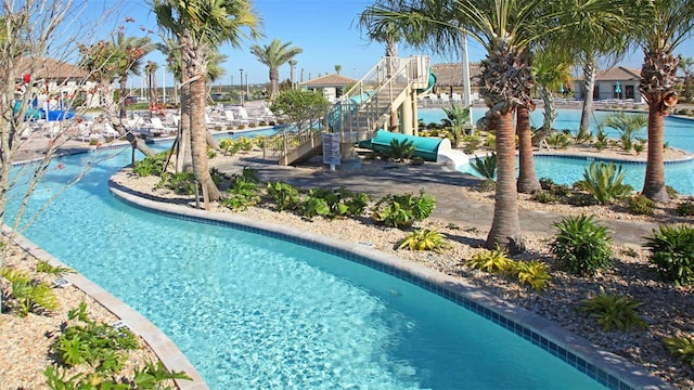 view of swimming pool with a water slide