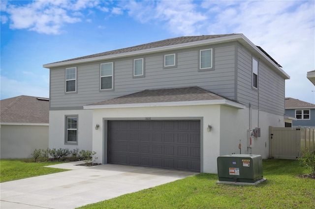 front of property with a front yard and a garage