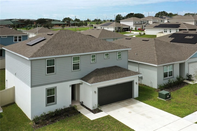 view of front of house featuring a front yard and solar panels