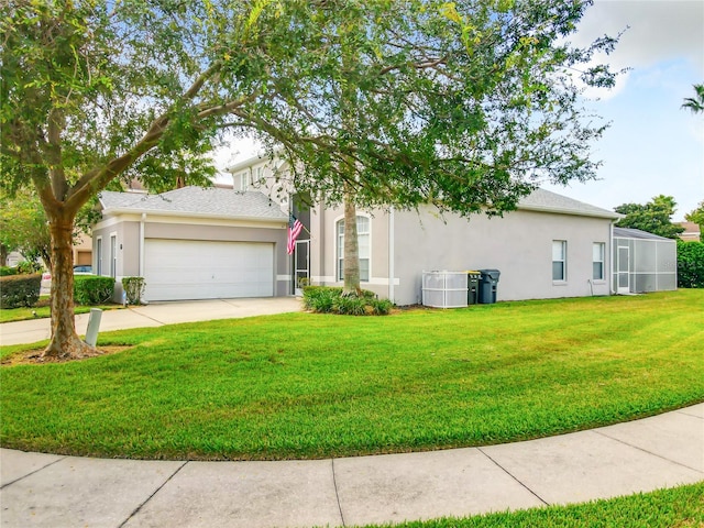 view of front of property featuring central AC, a front yard, and a garage