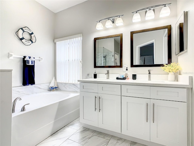 bathroom featuring tile floors, dual sinks, large vanity, and a bathtub