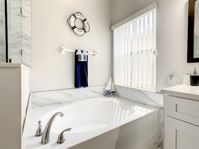 bathroom with vanity and a tub