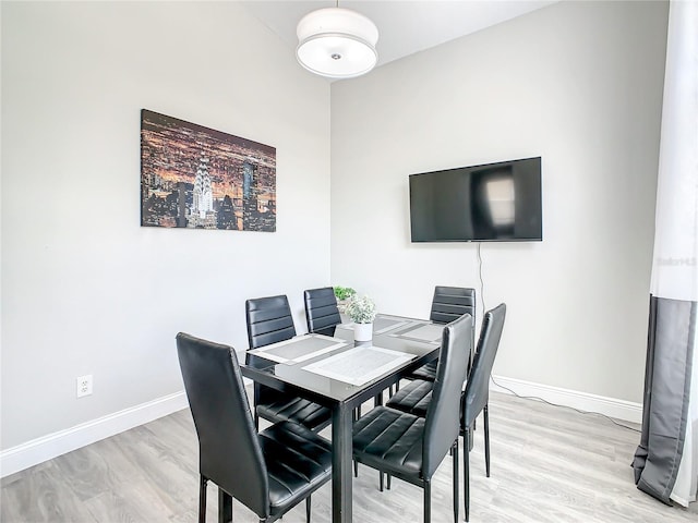 dining space with light wood-type flooring