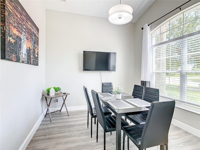 dining space with light wood-type flooring