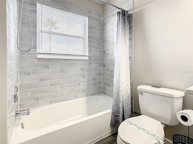 bathroom with shower / bath combination with curtain and toilet