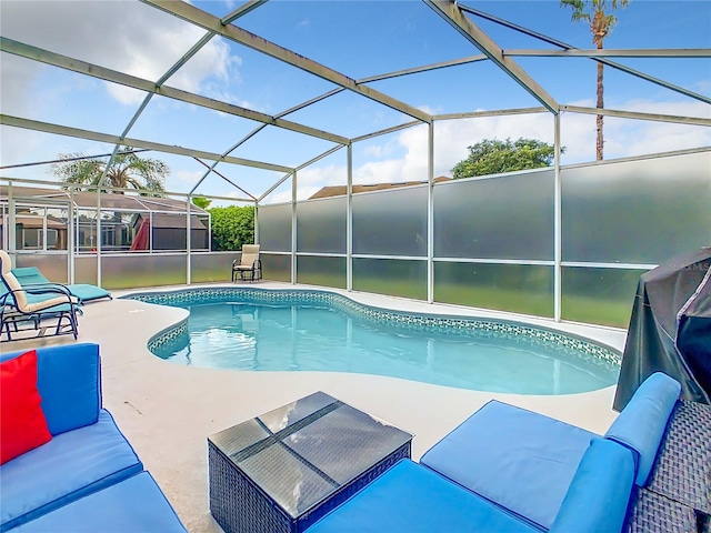 view of swimming pool with glass enclosure and a patio area