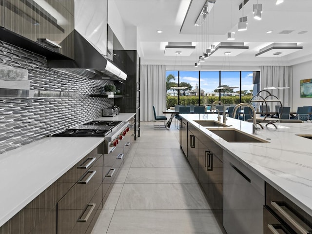 kitchen with backsplash, decorative light fixtures, sink, and dishwasher