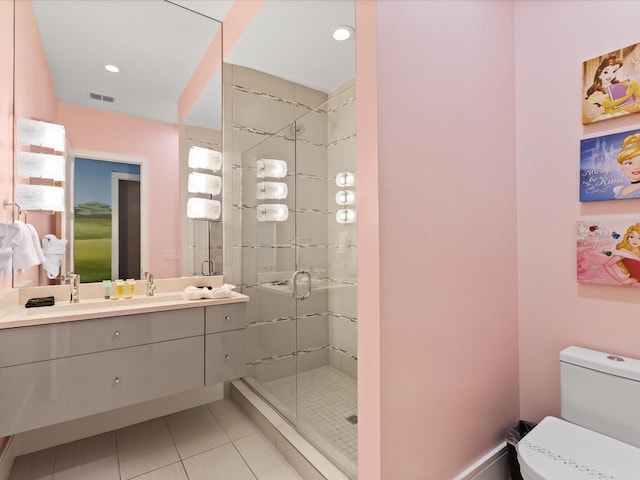 bathroom featuring a shower with door, tile flooring, oversized vanity, and toilet