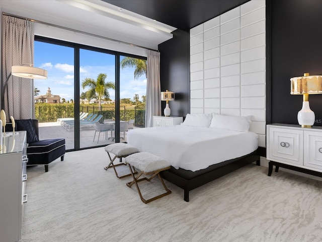 bedroom featuring light colored carpet and access to outside