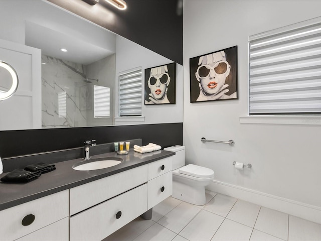 bathroom with vanity, tile flooring, and toilet