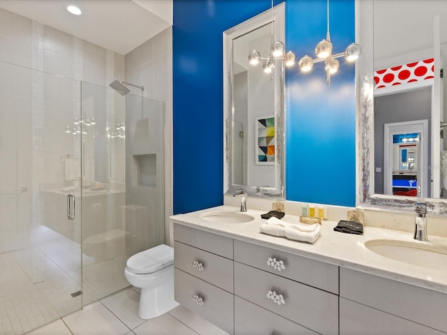 bathroom featuring double sink vanity, toilet, tile floors, and an enclosed shower