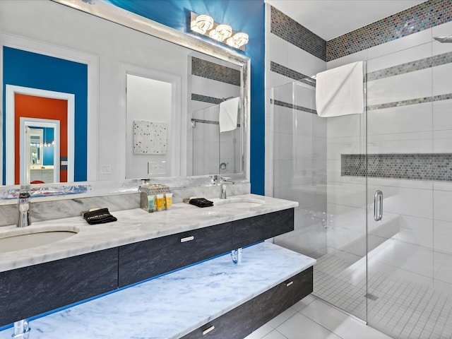 bathroom featuring tile floors, a shower with shower door, and dual vanity