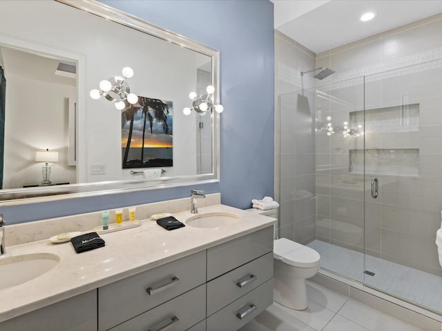 bathroom with toilet, double sink, vanity with extensive cabinet space, a shower with door, and tile floors