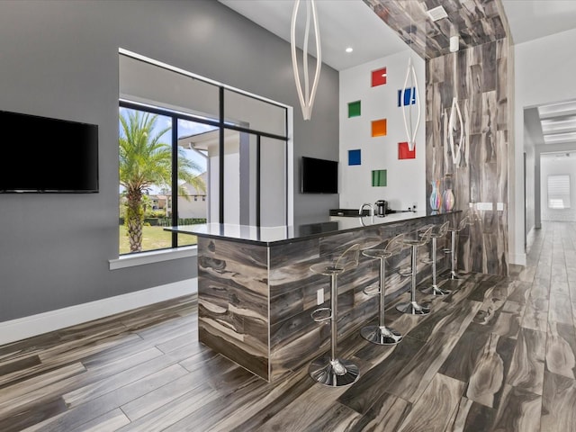 interior space with plenty of natural light and dark hardwood / wood-style flooring