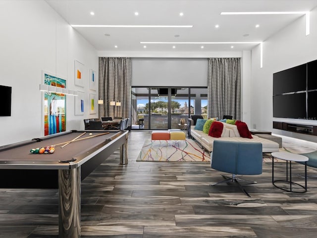 playroom featuring a high ceiling, pool table, and dark wood-type flooring