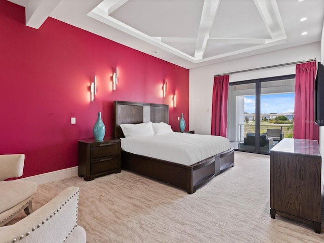 bedroom featuring a raised ceiling and access to outside