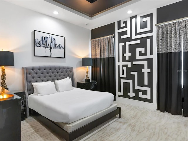 carpeted bedroom featuring a raised ceiling