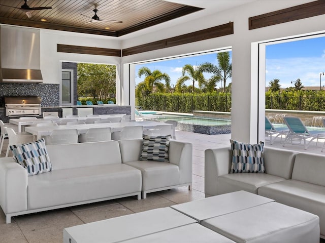 interior space with wood ceiling, ceiling fan, and a wealth of natural light