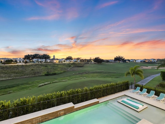 view of pool at dusk