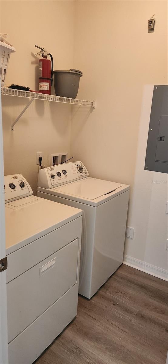 clothes washing area with separate washer and dryer and dark hardwood / wood-style floors