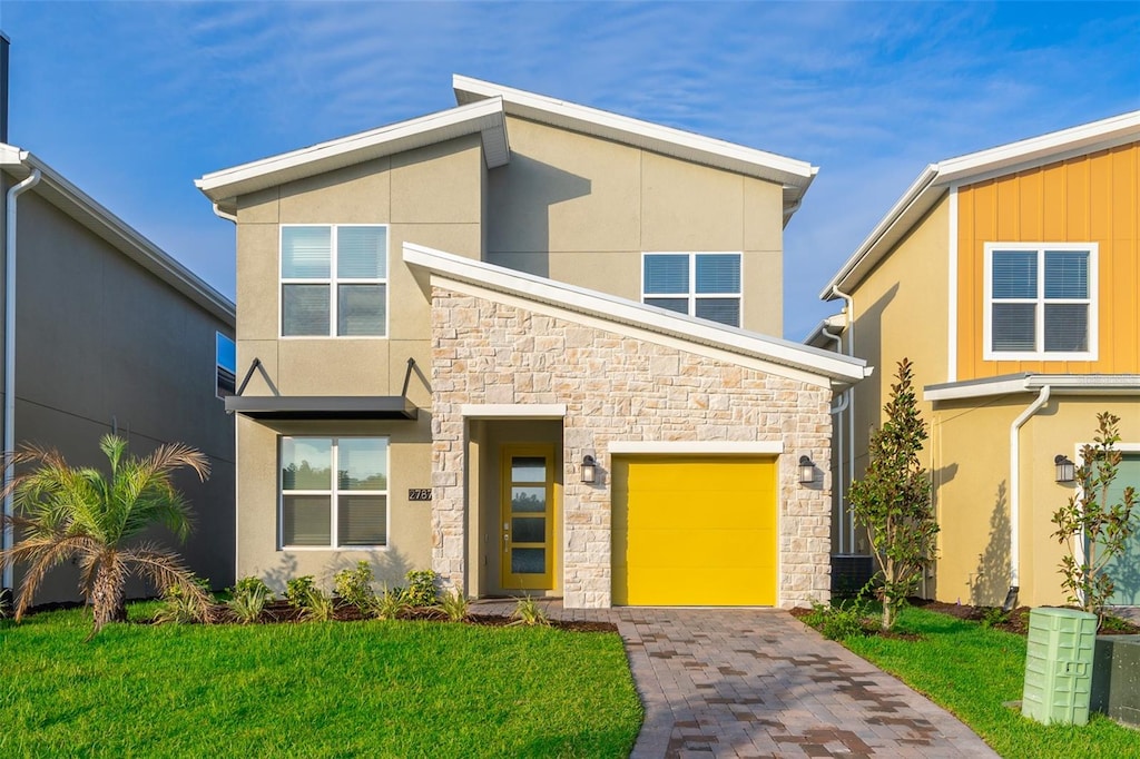 modern home featuring a front lawn and a garage