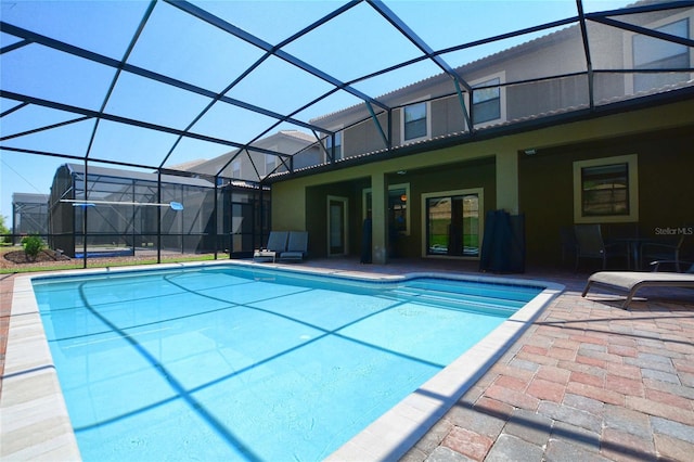 view of pool featuring a patio and glass enclosure