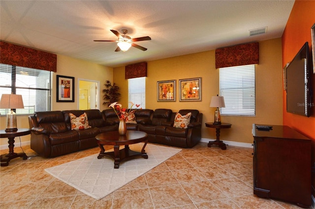 tiled living room featuring ceiling fan