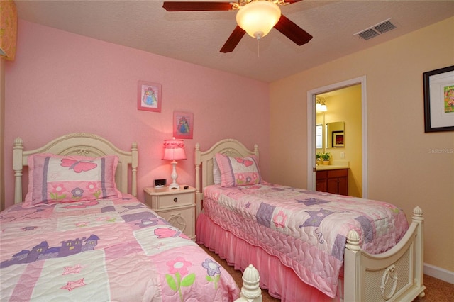 carpeted bedroom featuring ensuite bath and ceiling fan