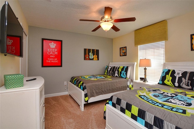 carpeted bedroom with a textured ceiling and ceiling fan