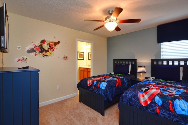 carpeted bedroom featuring connected bathroom, a textured ceiling, and ceiling fan