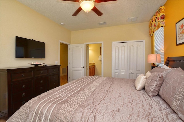 bedroom featuring ensuite bathroom, a closet, ceiling fan, and a textured ceiling