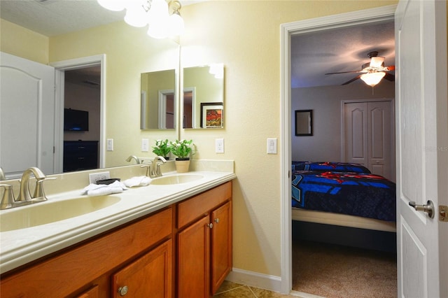 bathroom with double sink vanity, tile floors, ceiling fan, and a textured ceiling