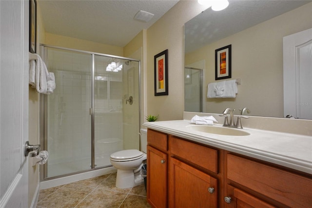 bathroom with toilet, an enclosed shower, tile flooring, a textured ceiling, and large vanity