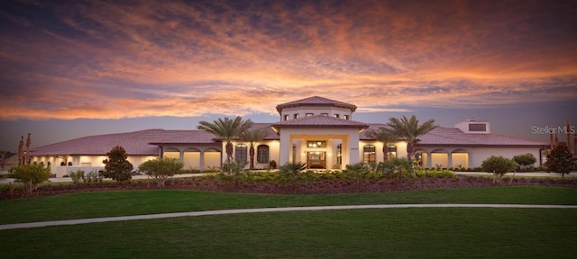 mediterranean / spanish-style home featuring a yard