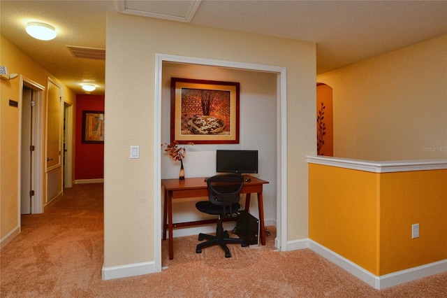 carpeted home office featuring a textured ceiling