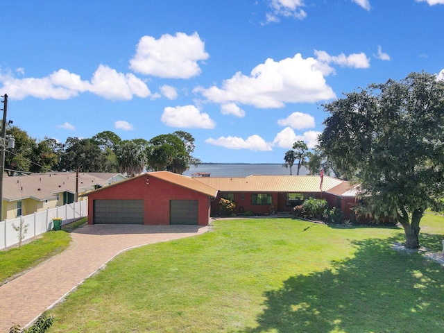 single story home featuring a front lawn and a garage