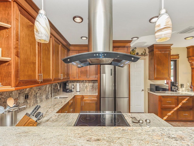 kitchen with appliances with stainless steel finishes, sink, tasteful backsplash, island exhaust hood, and pendant lighting