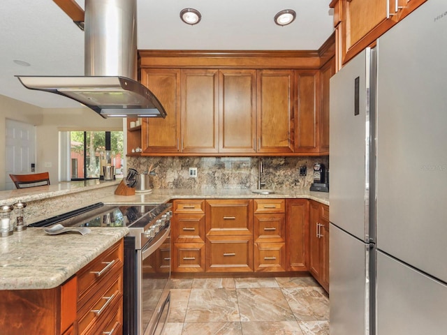 kitchen with white refrigerator, light tile flooring, light stone countertops, high end stove, and island exhaust hood