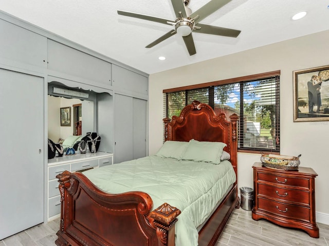 bedroom with ceiling fan and light hardwood / wood-style flooring