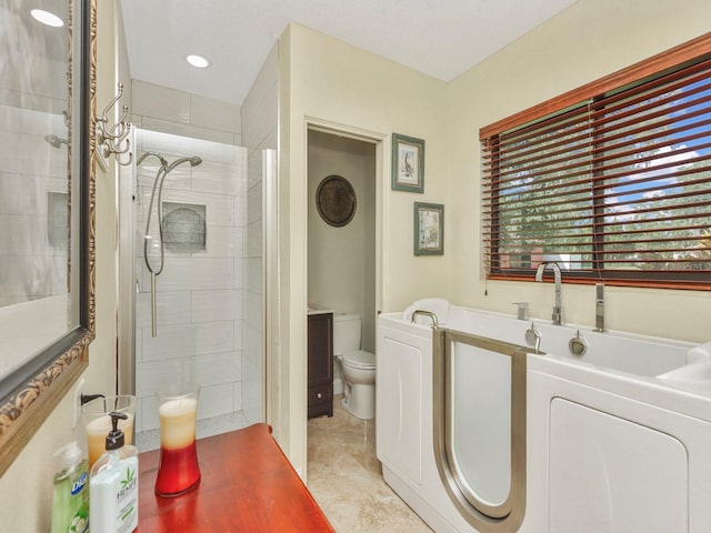 bathroom featuring toilet, vanity, a shower with shower door, and tile flooring