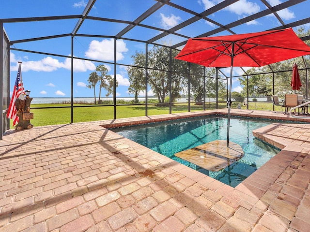 view of swimming pool featuring a lawn, glass enclosure, and a patio