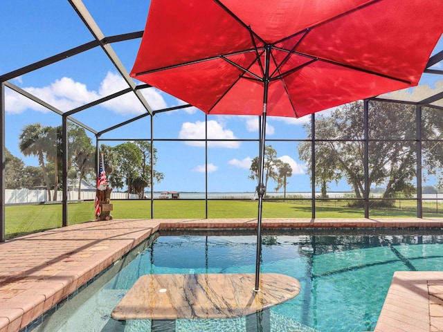 view of swimming pool with a yard and a lanai