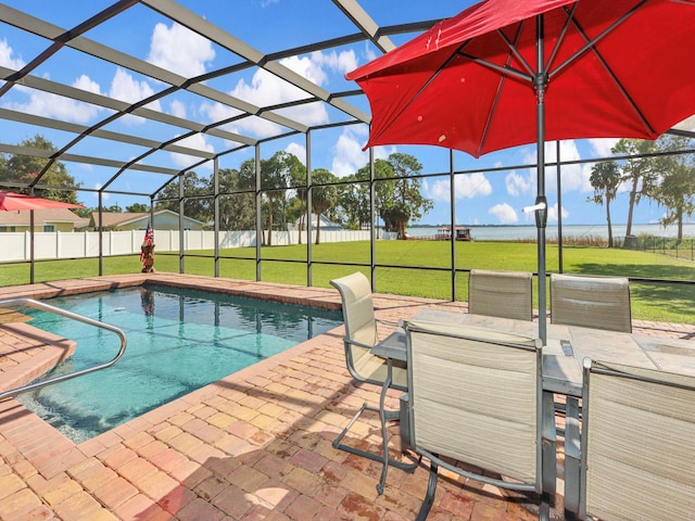 view of swimming pool featuring a lawn, glass enclosure, and a patio