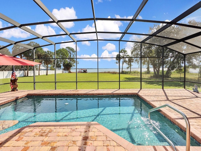 view of swimming pool featuring glass enclosure, a yard, and a patio area