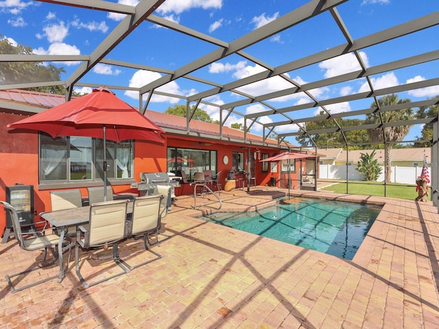 view of swimming pool featuring a lanai and a patio area