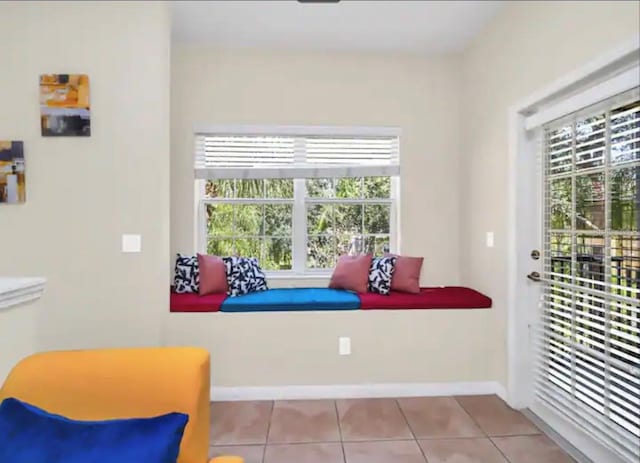 living area featuring plenty of natural light and light tile floors