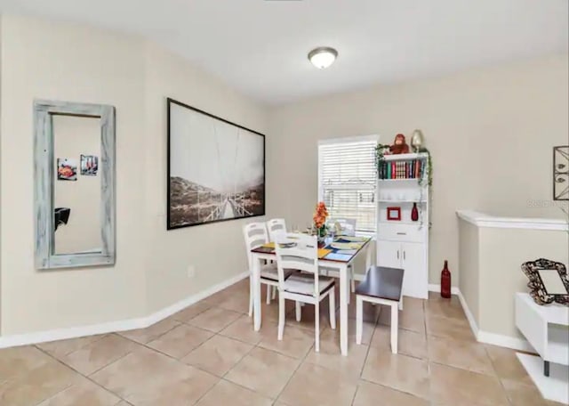 dining space with light tile flooring