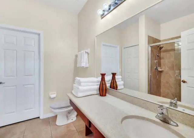 bathroom with vanity, tile floors, and toilet