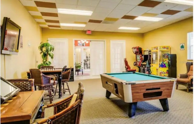 game room with light colored carpet, pool table, and a drop ceiling